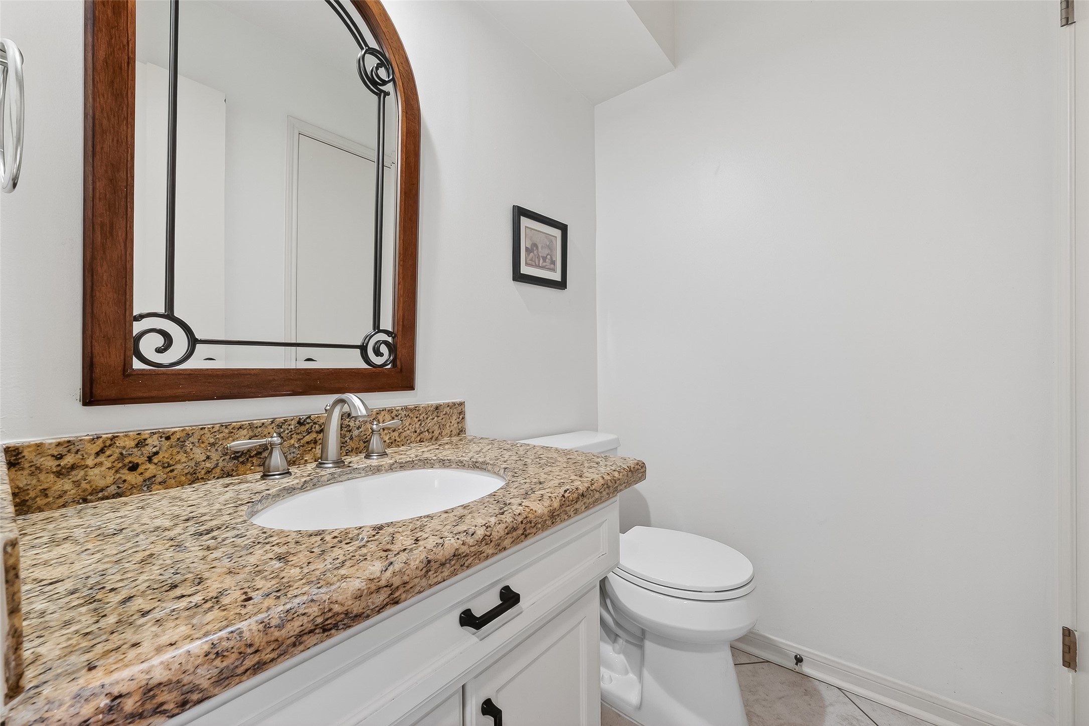 14690 Perthshire Road, Unit C Houston, TX 77079 - Photo 27 of 48 A polished powder room featuring a refined vanity and bright fixtures, strategically placed for guest convenience.