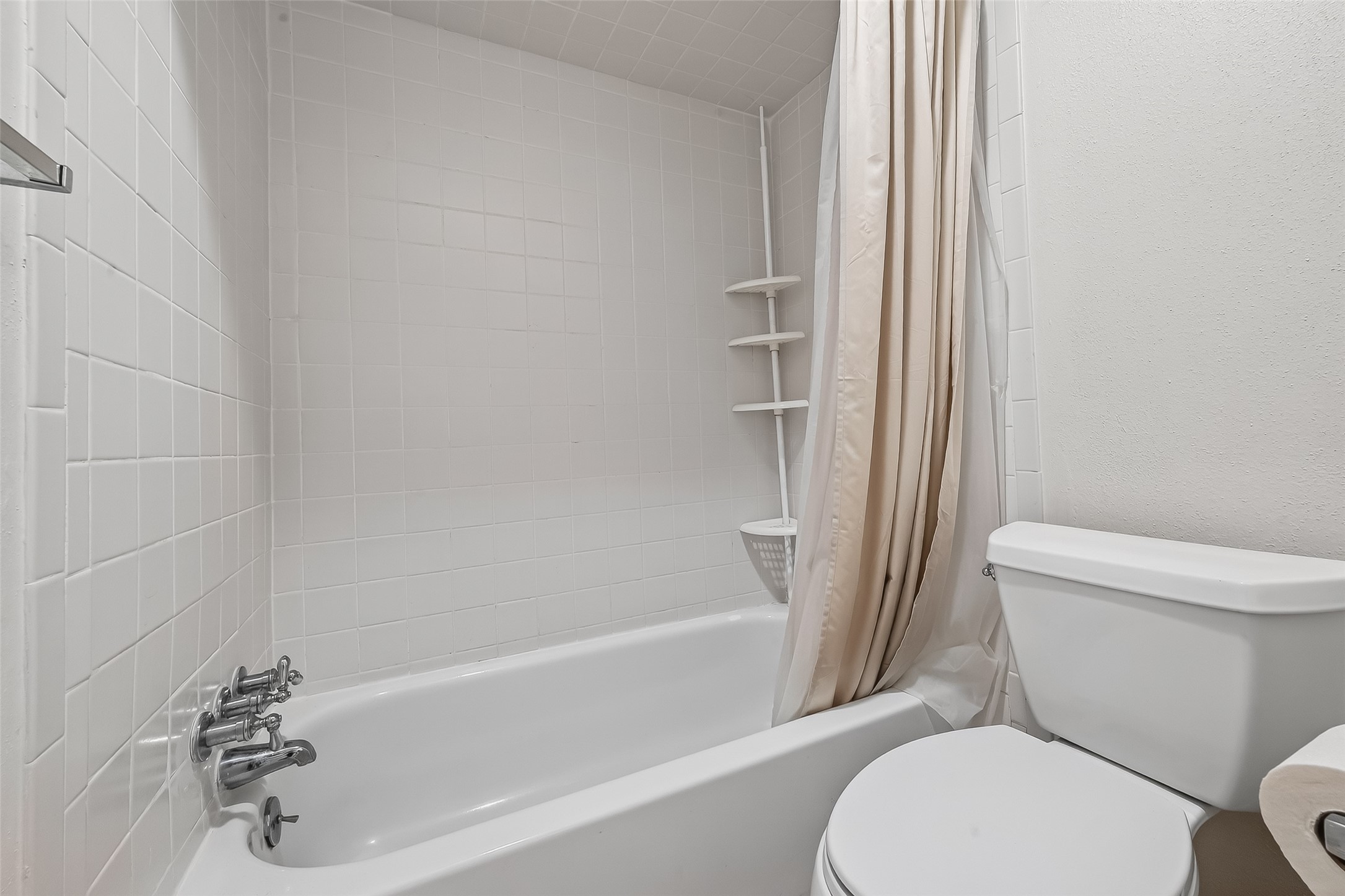 14690 Perthshire Road, Unit C Houston, TX 77079 - Photo 35 of 48 The full bathroom features a timeless tile surround in the shower-and-tub combination, offering a clean and durable aesthetic.