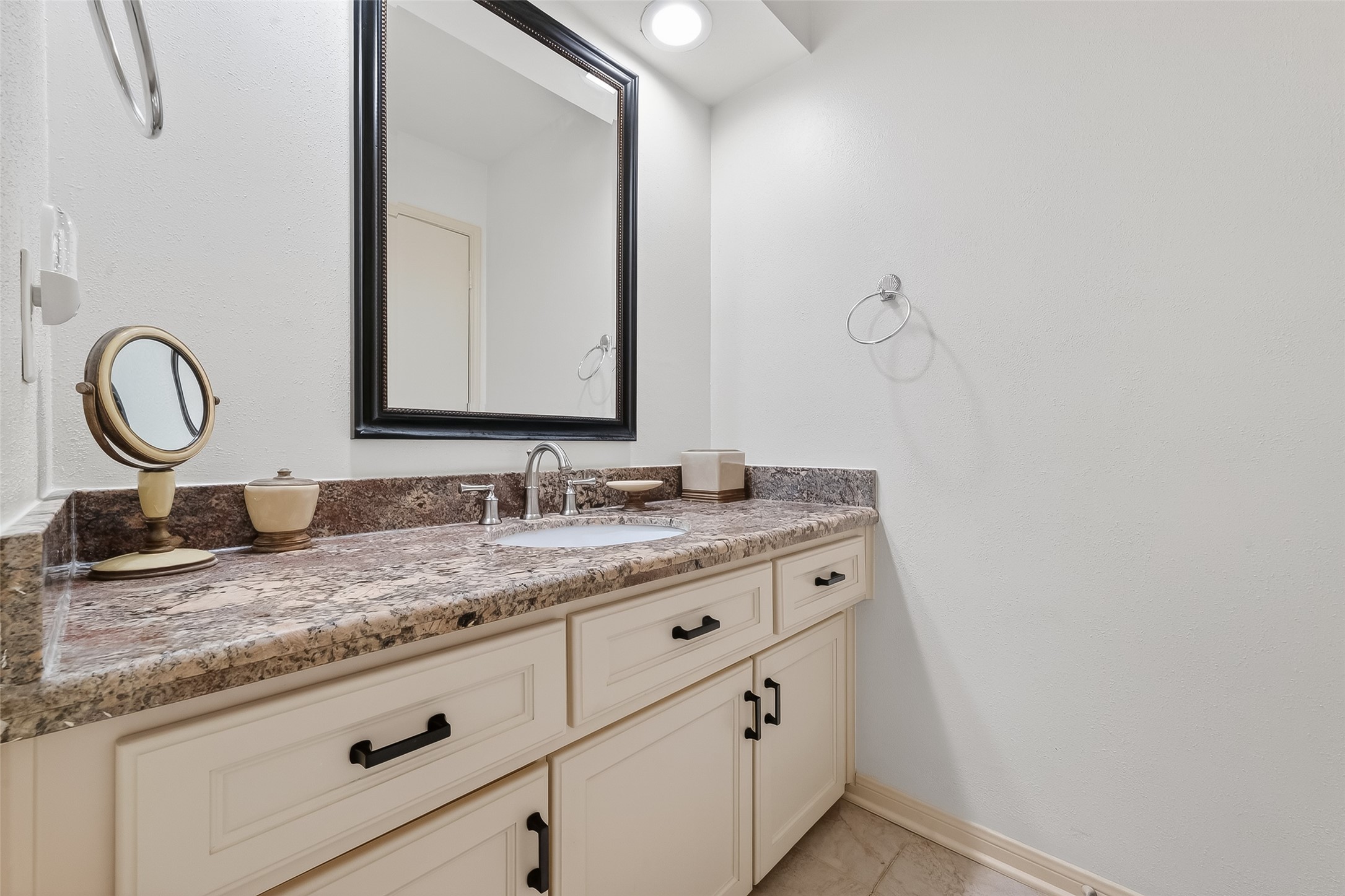 14690 Perthshire Road, Unit C Houston, TX 77079 - Photo 36 of 48 A large, independent vanity area provides a dedicated space for morning routines, thoughtfully separate from the bathroom.