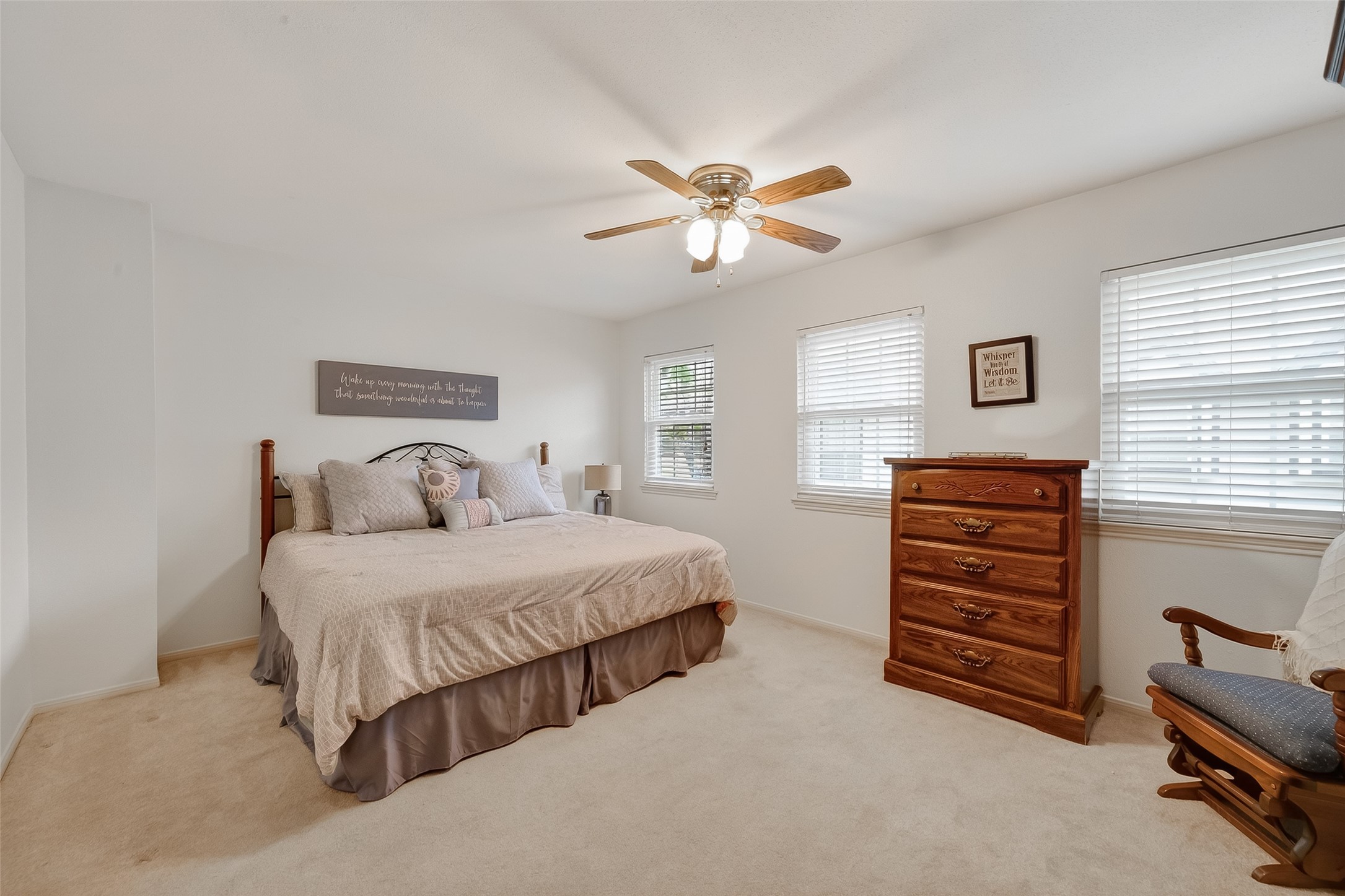 14690 Perthshire Road, Unit C Houston, TX 77079 - Photo 38 of 48 Multiple large windows fill this carpeted primary suite with light, creating a restful and cozy haven for end-of-day relaxation.