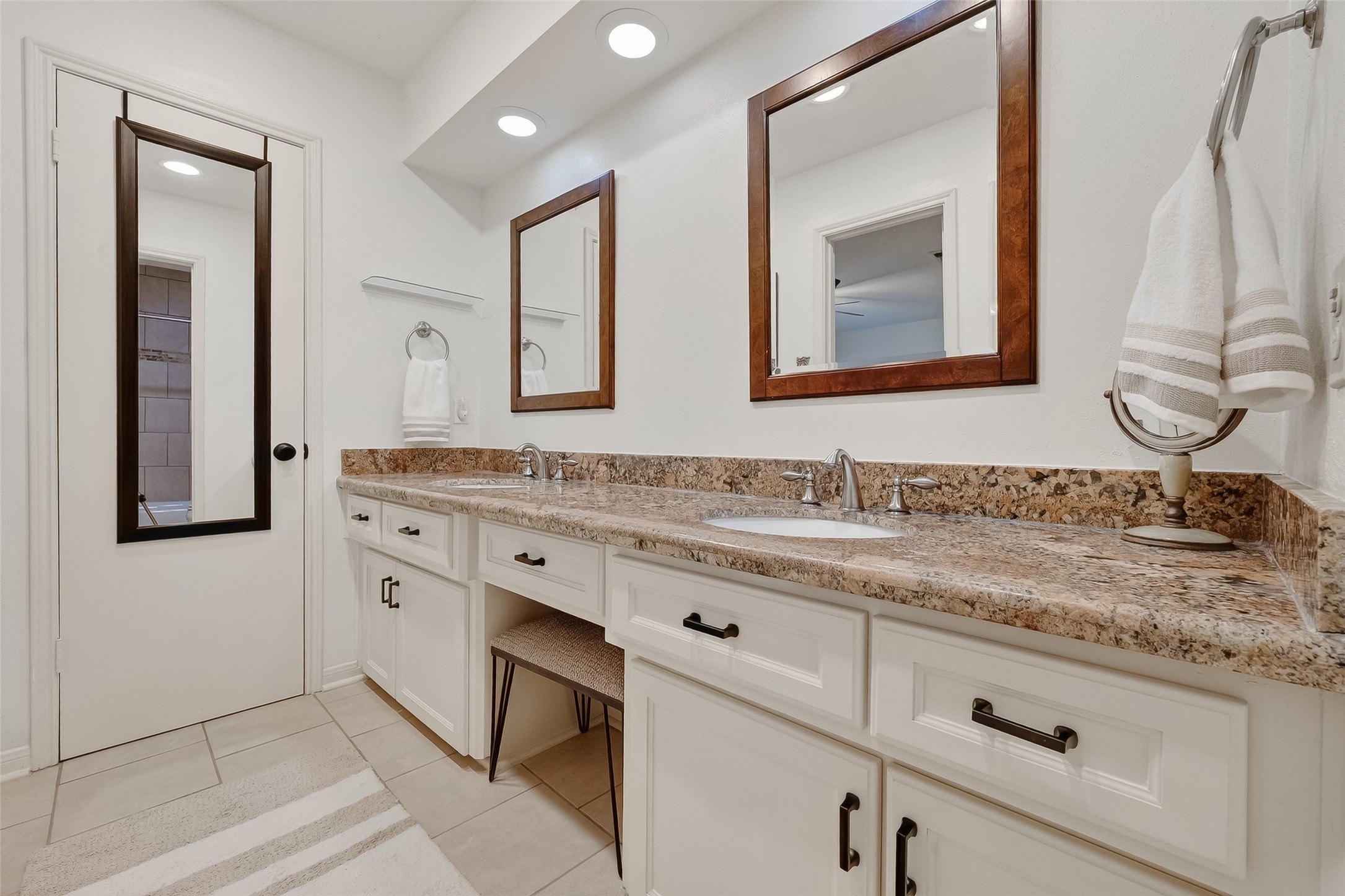 14690 Perthshire Road, Unit C Houston, TX 77079 - Photo 42 of 48 An expansive dual-sink vanity with ample under storage, perfectly illuminated to serve as a deluxe grooming station.