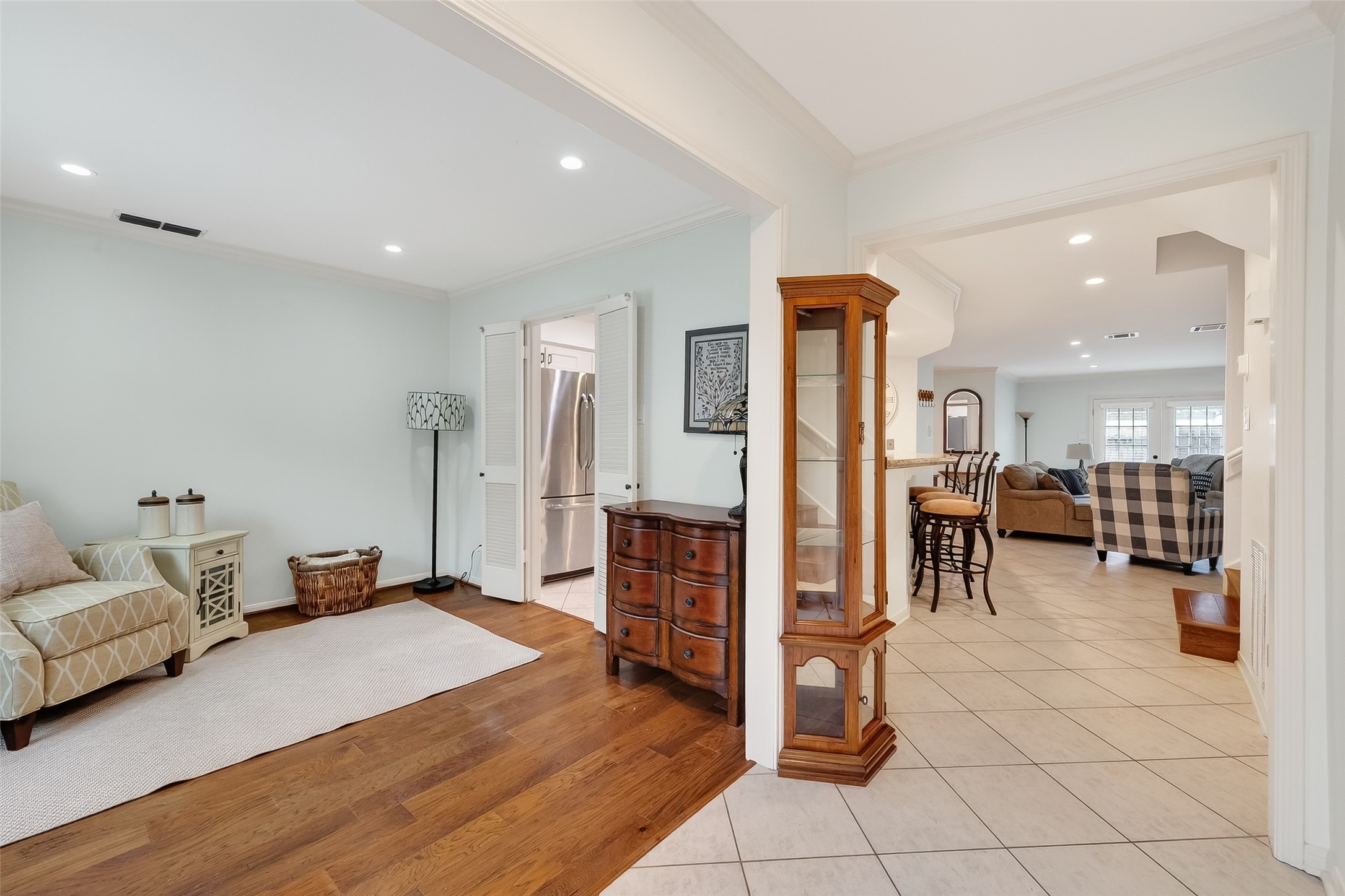 14690 Perthshire Road, Unit C Houston, TX 77079 - Photo 7 of 48 From the threshold, crown molding and beautiful tiled floors lead the eye toward the home’s main living spaces.
