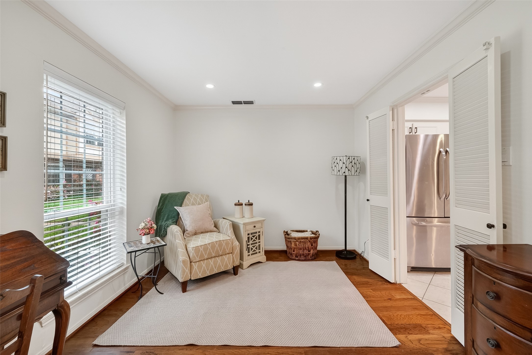 14690 Perthshire Road, Unit C Houston, TX 77079 - Photo 8 of 48 This elegant space features rich wood flooring and an oversized window, functioning perfectly as a formal living or dining room that opens to the kitchen through double doors.