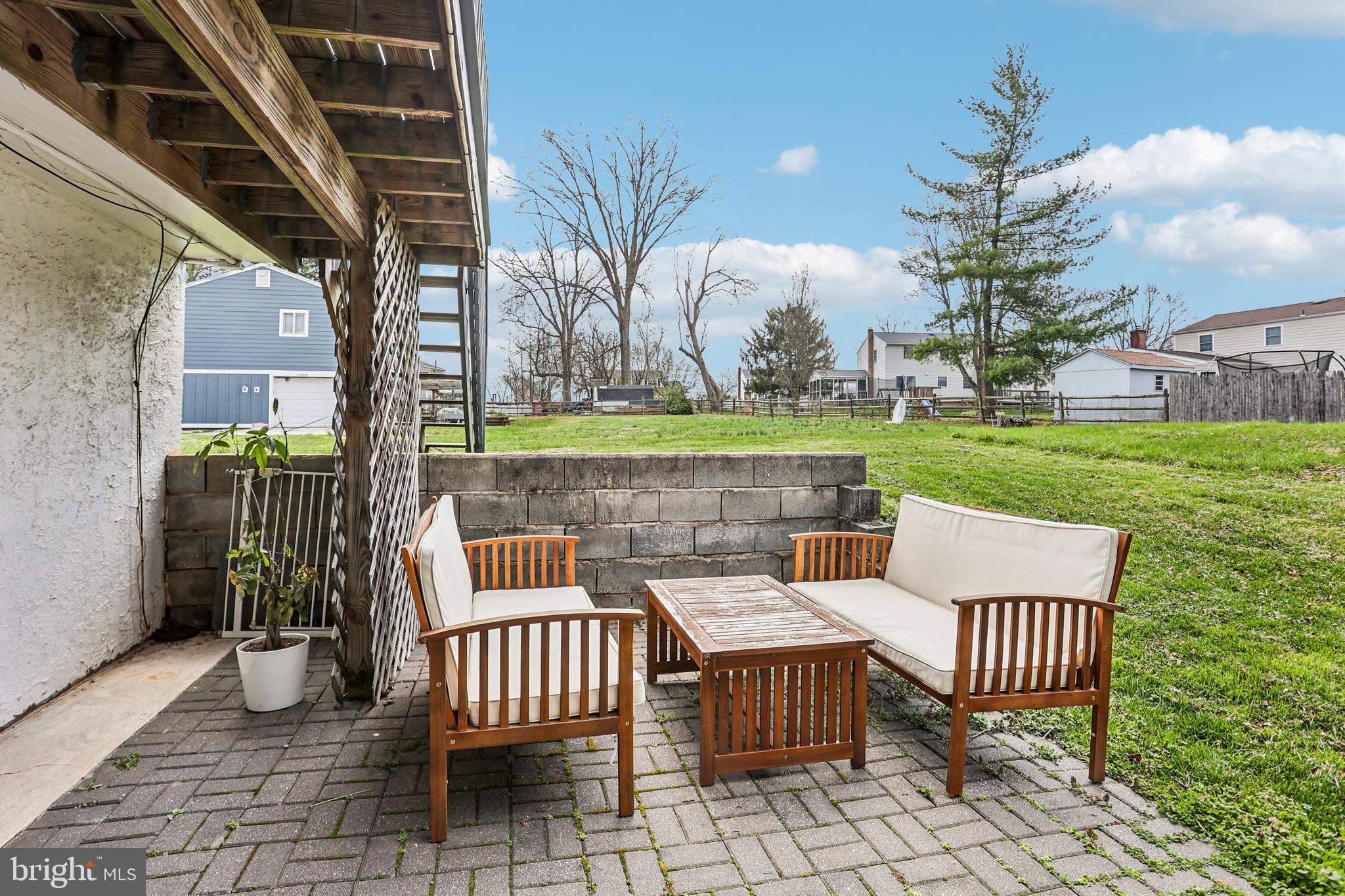 15 Brimfield Road Audubon, PA 19403 - Photo 37 of 41 a view of a patio with table and chairs and potted plants