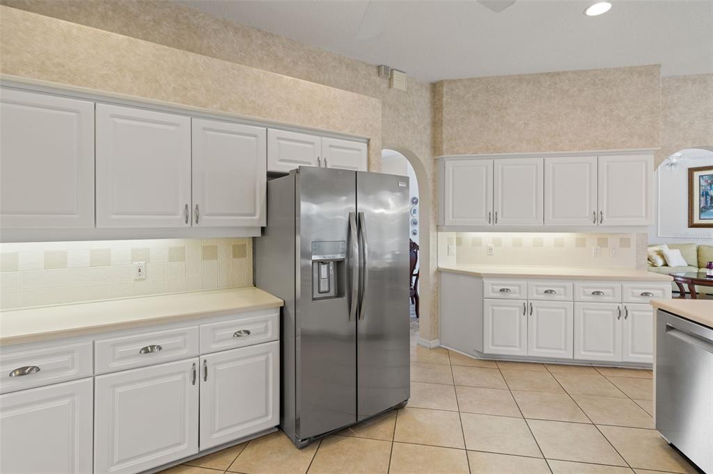 8405 Maybelle Drive Weeki Wachee, FL 34613 - Photo 12 of 61 a kitchen with a refrigerator sink and cabinets