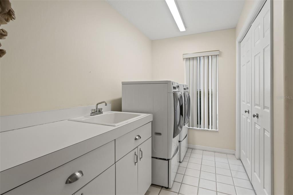 8405 Maybelle Drive Weeki Wachee, FL 34613 - Photo 13 of 61 a utility room with dryer and washer
