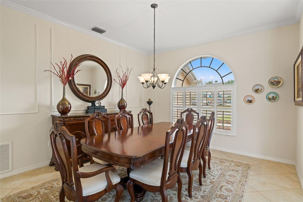 8405 Maybelle Drive Weeki Wachee, FL 34613 - Photo 19 of 61 a view of a dining room with furniture and chandelier
