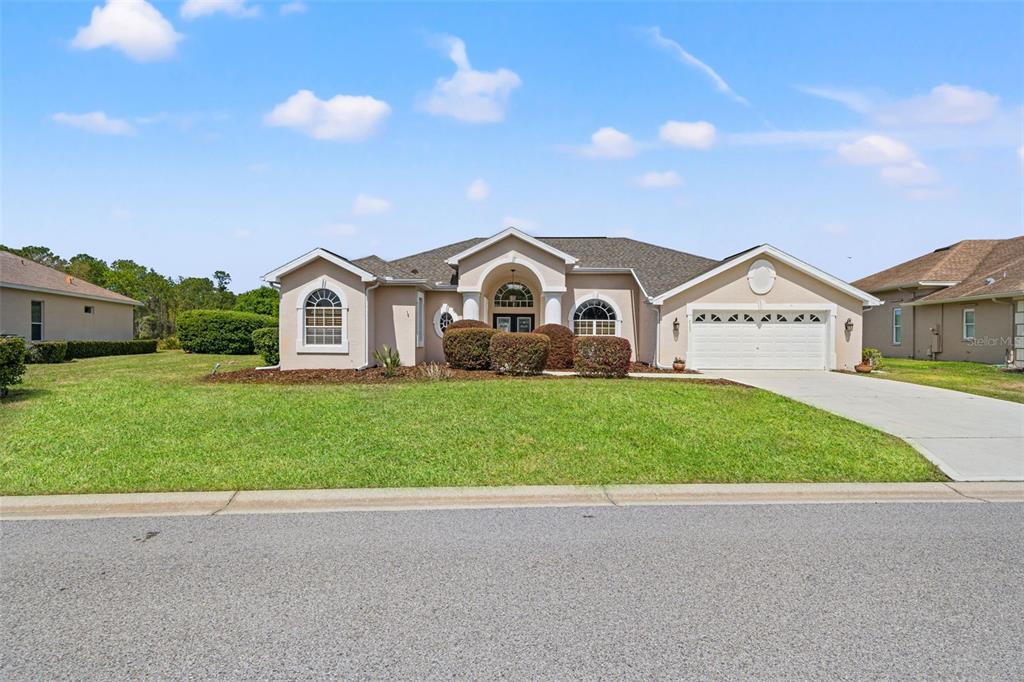 8405 Maybelle Drive Weeki Wachee, FL 34613 - Photo 2 of 61 a view of white house with a big yard and large trees