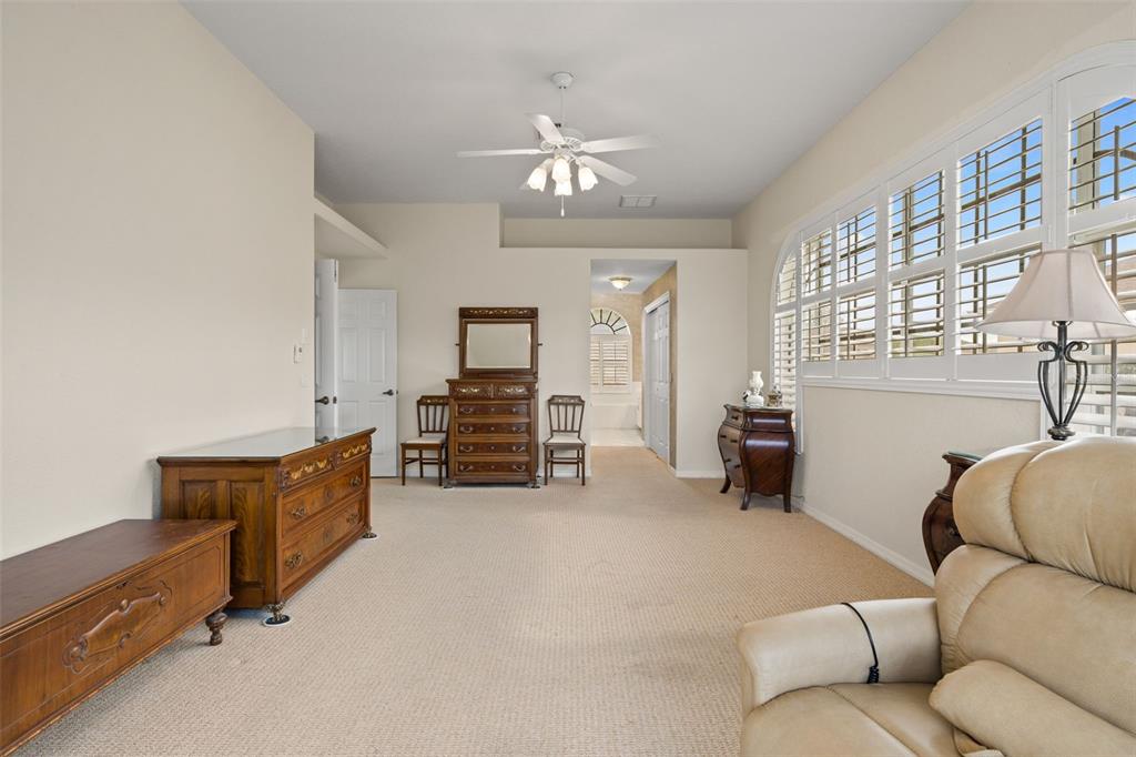 8405 Maybelle Drive Weeki Wachee, FL 34613 - Photo 25 of 61 a living room with furniture and a chandelier