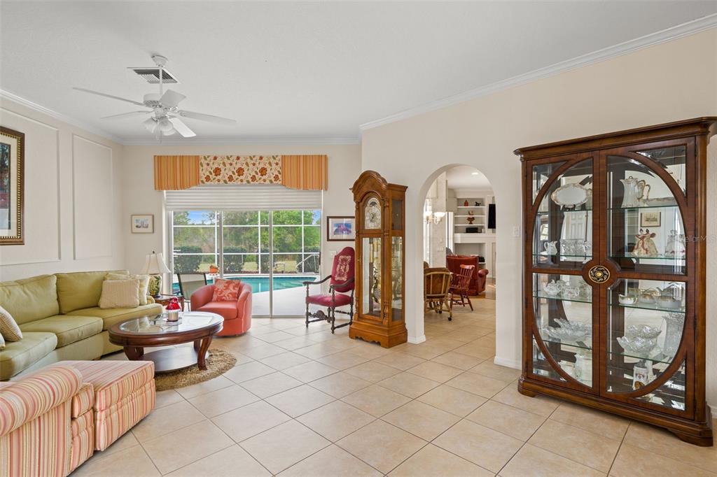 8405 Maybelle Drive Weeki Wachee, FL 34613 - Photo 5 of 61 a living room with furniture a large window and gym equipment