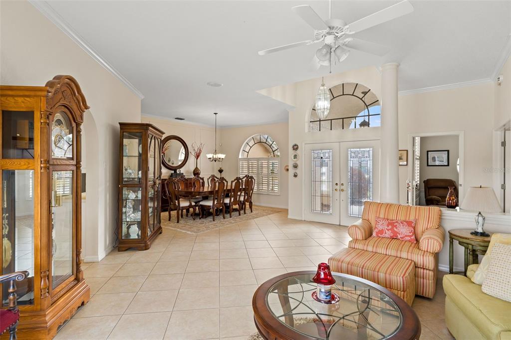 8405 Maybelle Drive Weeki Wachee, FL 34613 - Photo 7 of 61 a living room with furniture chandelier and a flat screen tv
