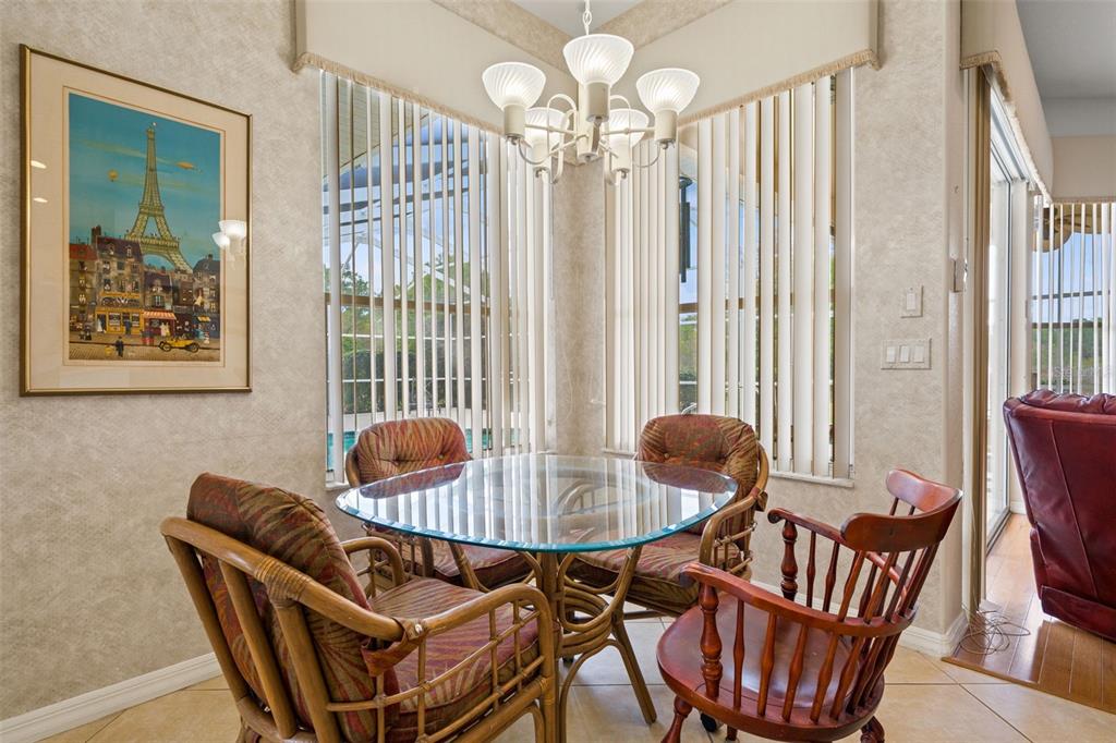 8405 Maybelle Drive Weeki Wachee, FL 34613 - Photo 8 of 61 a view of a dining room with furniture and chandelier