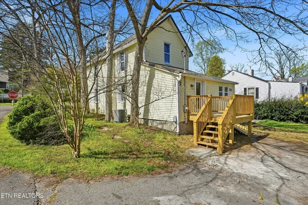 a view of a chairs and table in the backyard
