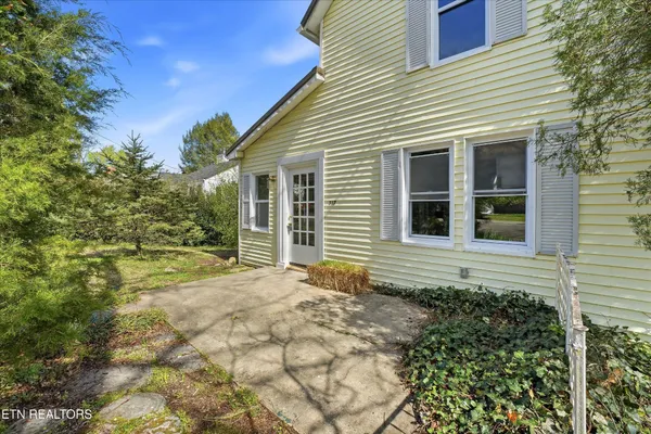 a view of house with backyard and garden
