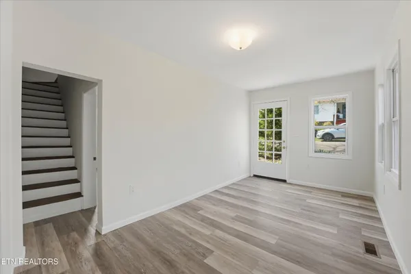 an empty room with windows and closet