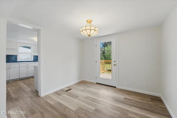 an empty room with windows and cabinet