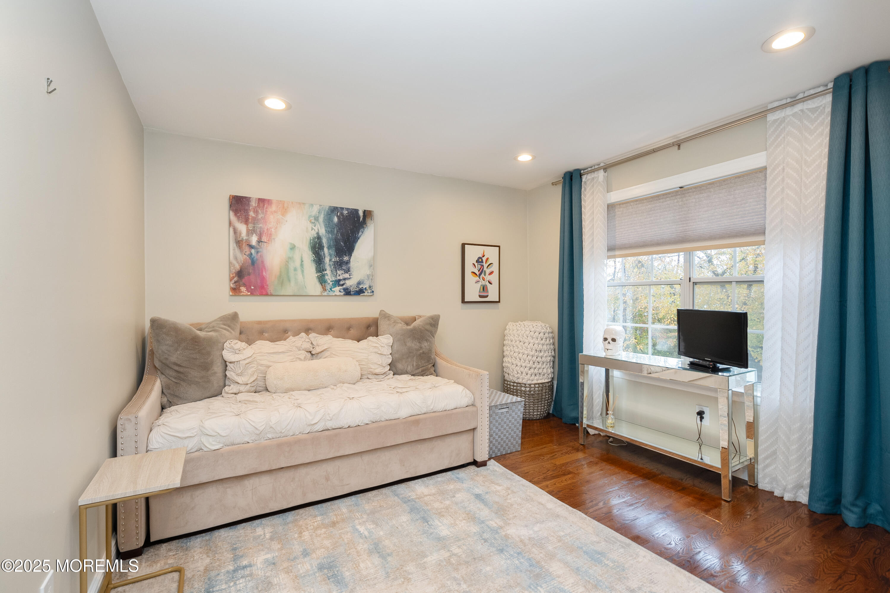 121 Milton Avenue Cliffwood, NJ 07721 - Photo 13 of 34 a spacious bedroom with a bed and a flat screen tv