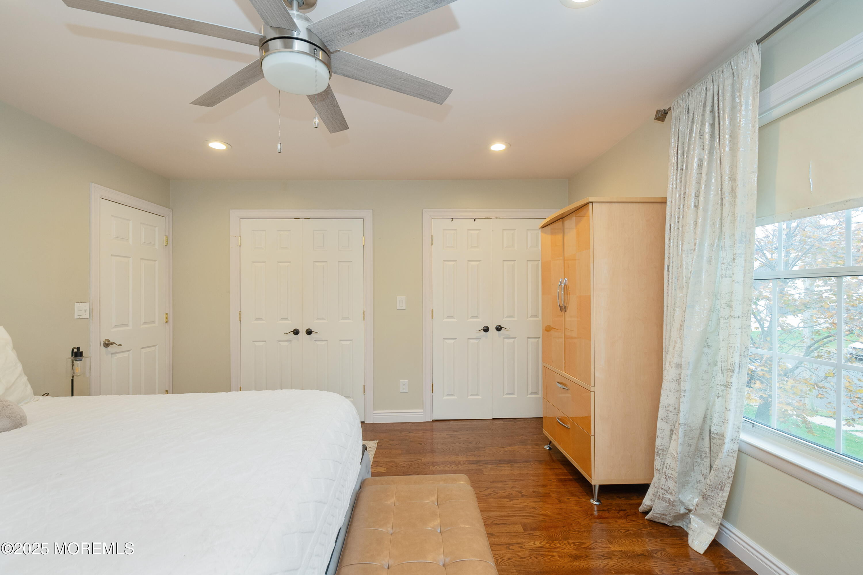 121 Milton Avenue Cliffwood, NJ 07721 - Photo 14 of 34 a spacious bedroom with a large bed and a chandelier fan