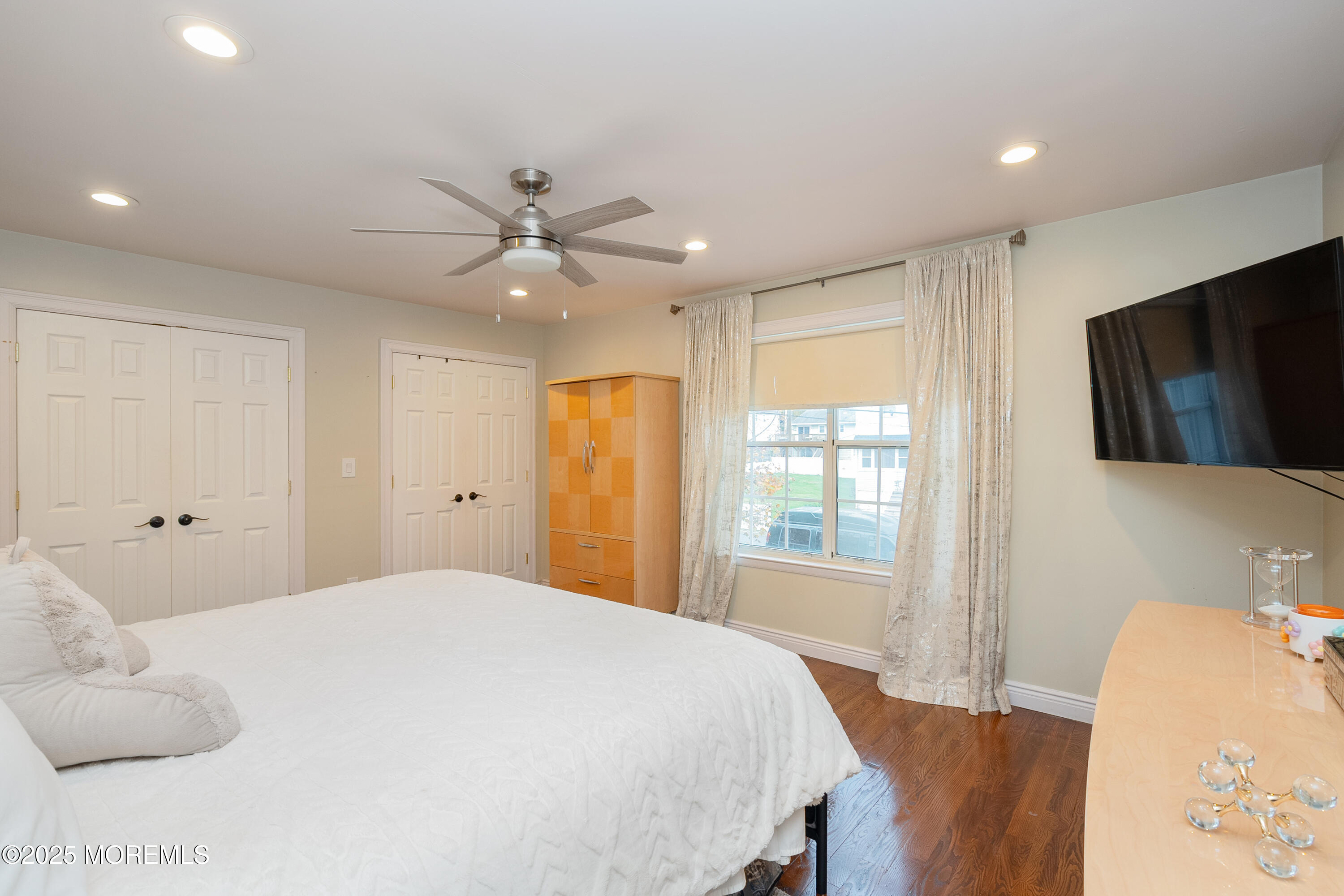 121 Milton Avenue Cliffwood, NJ 07721 - Photo 15 of 34 a bedroom with a large bed and a flat screen tv