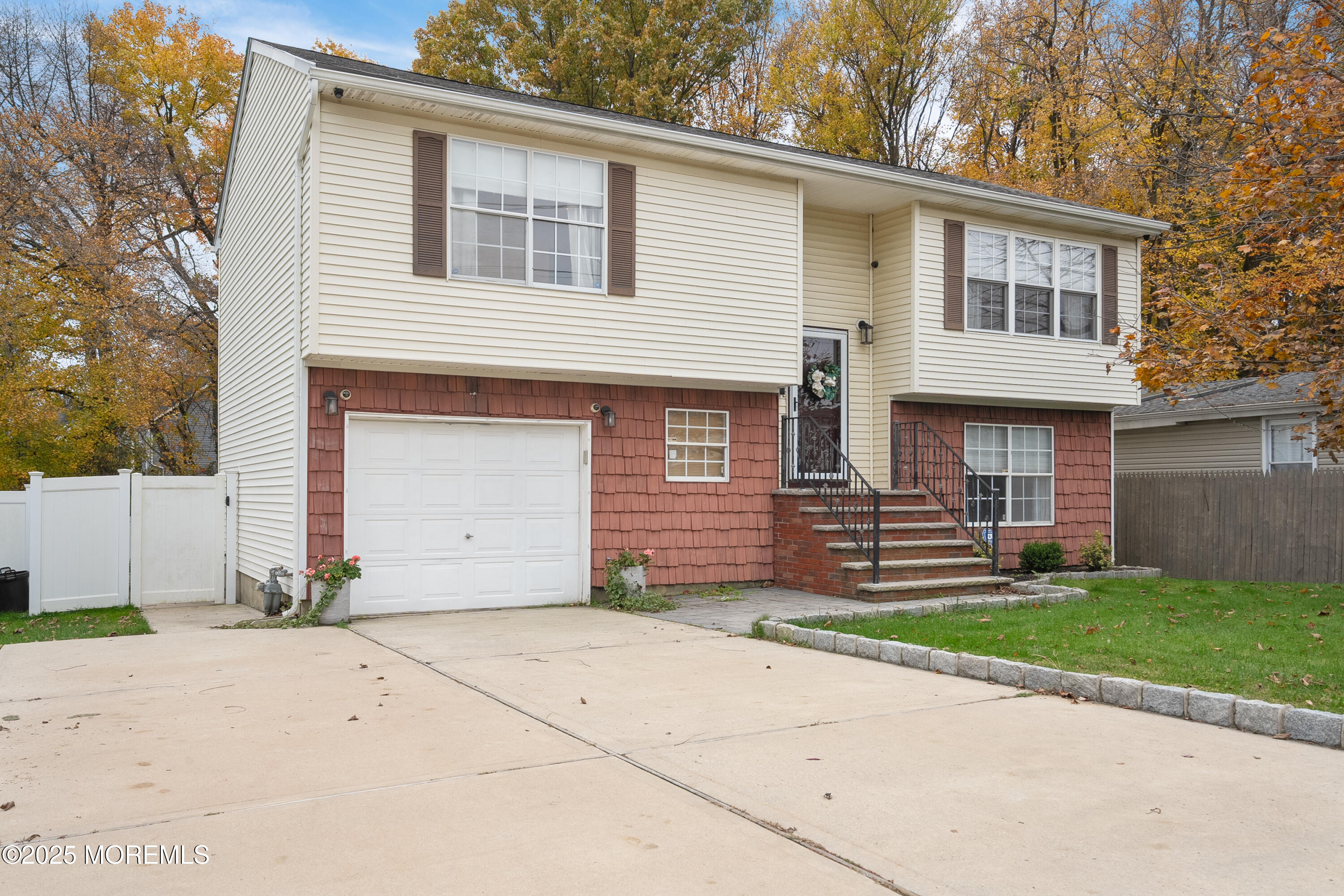 121 Milton Avenue Cliffwood, NJ 07721 - Photo 2 of 34 a front view of a house with a yard and garage