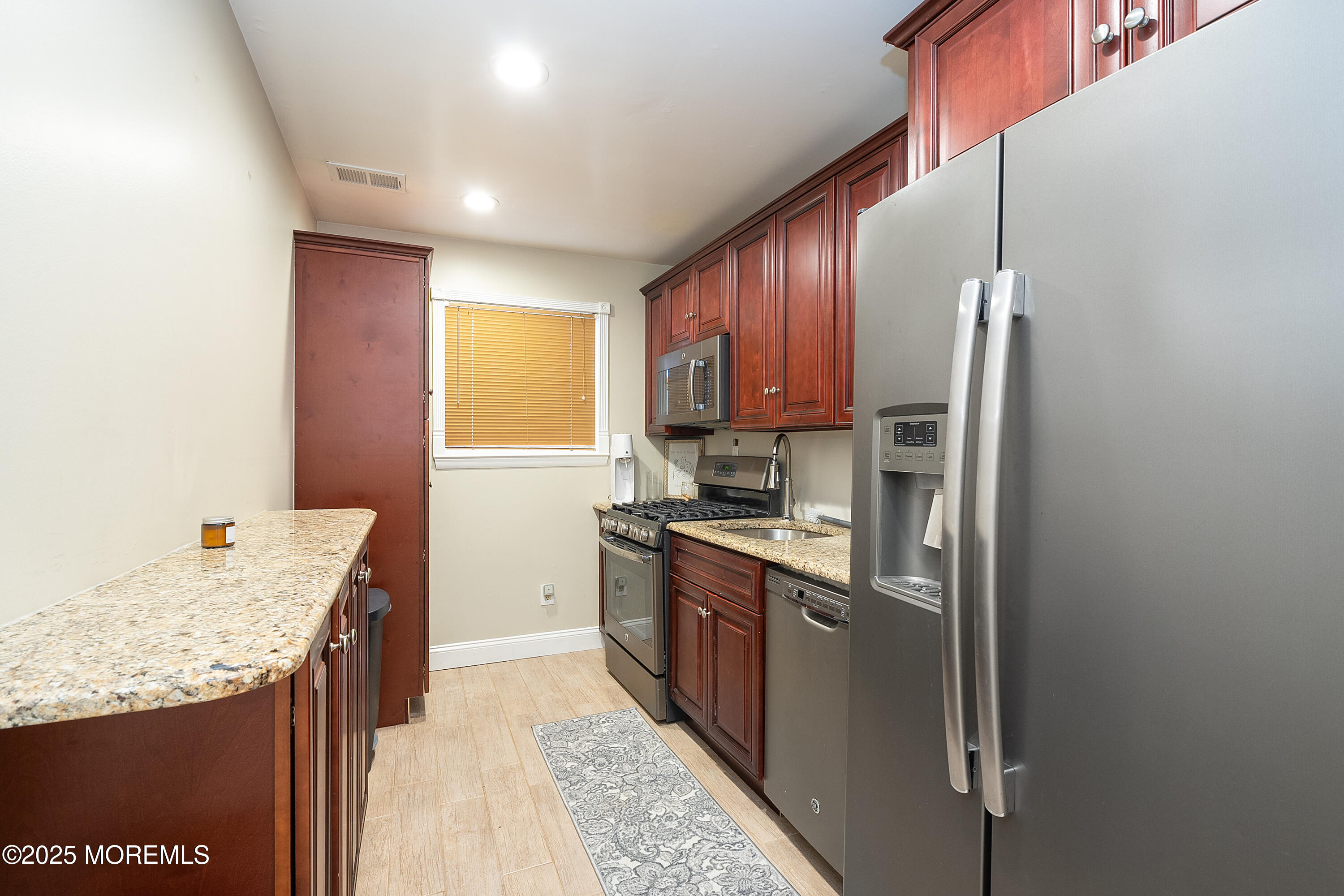 121 Milton Avenue Cliffwood, NJ 07721 - Photo 27 of 34 a kitchen with granite countertop a sink stove and refrigerator