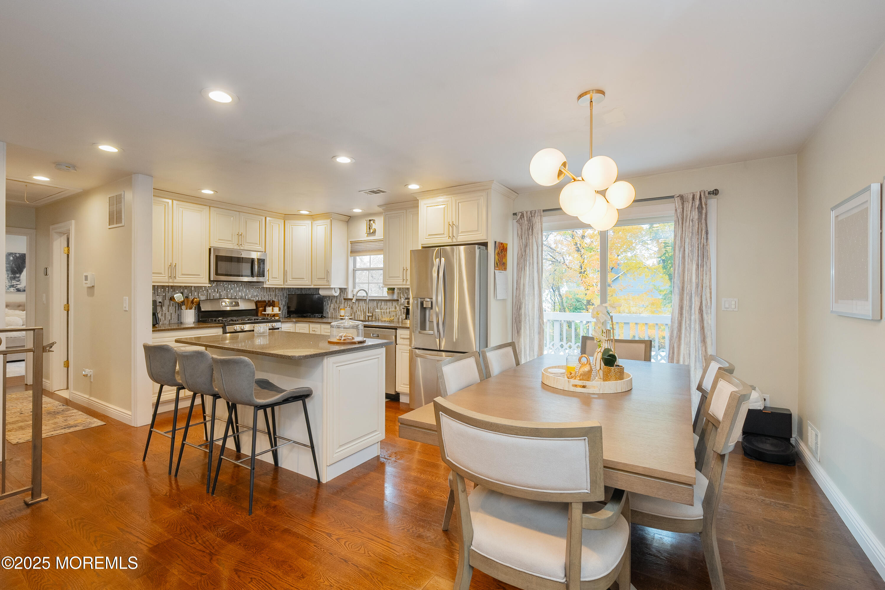 121 Milton Avenue Cliffwood, NJ 07721 - Photo 7 of 34 a kitchen with a dining table chairs and refrigerator