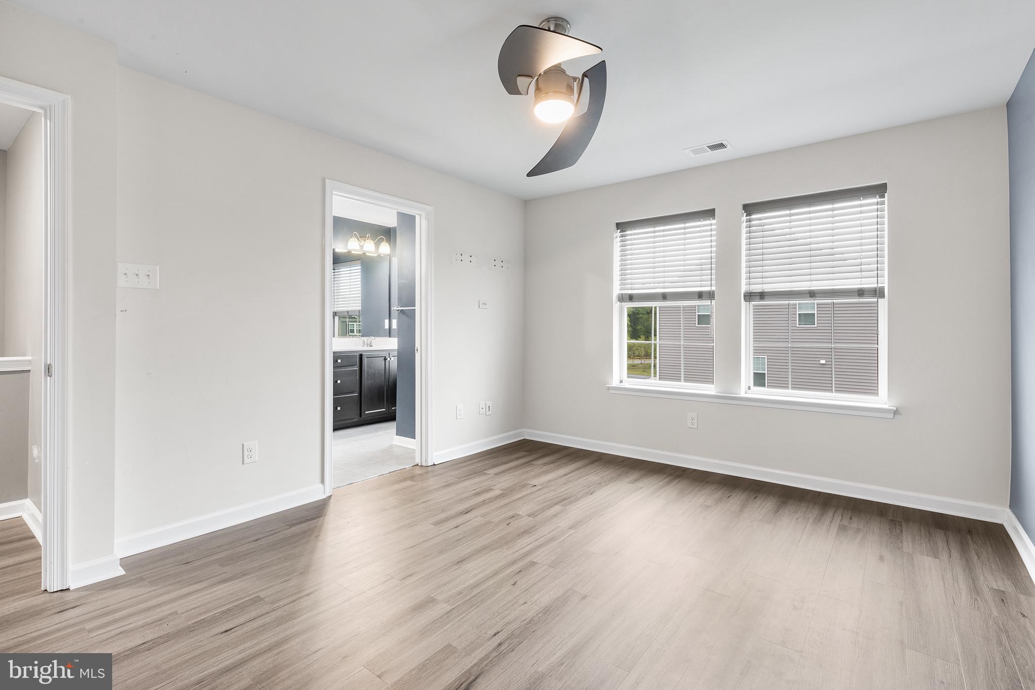 62 Rome Way Mount Laurel, NJ 08054 - Photo 26 of 31 an empty room with wooden floor cabinet and windows