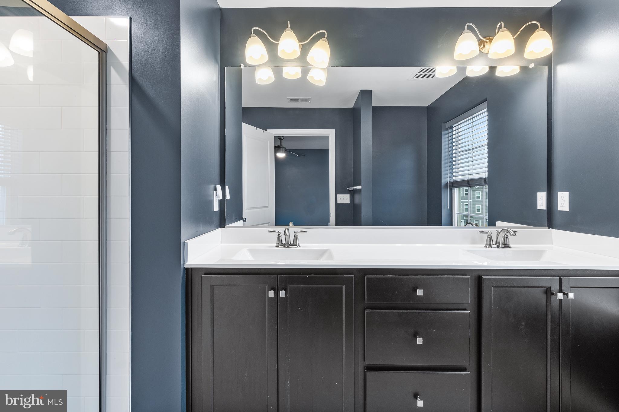 62 Rome Way Mount Laurel, NJ 08054 - Photo 28 of 31 a bathroom with a double vanity sink and a mirror