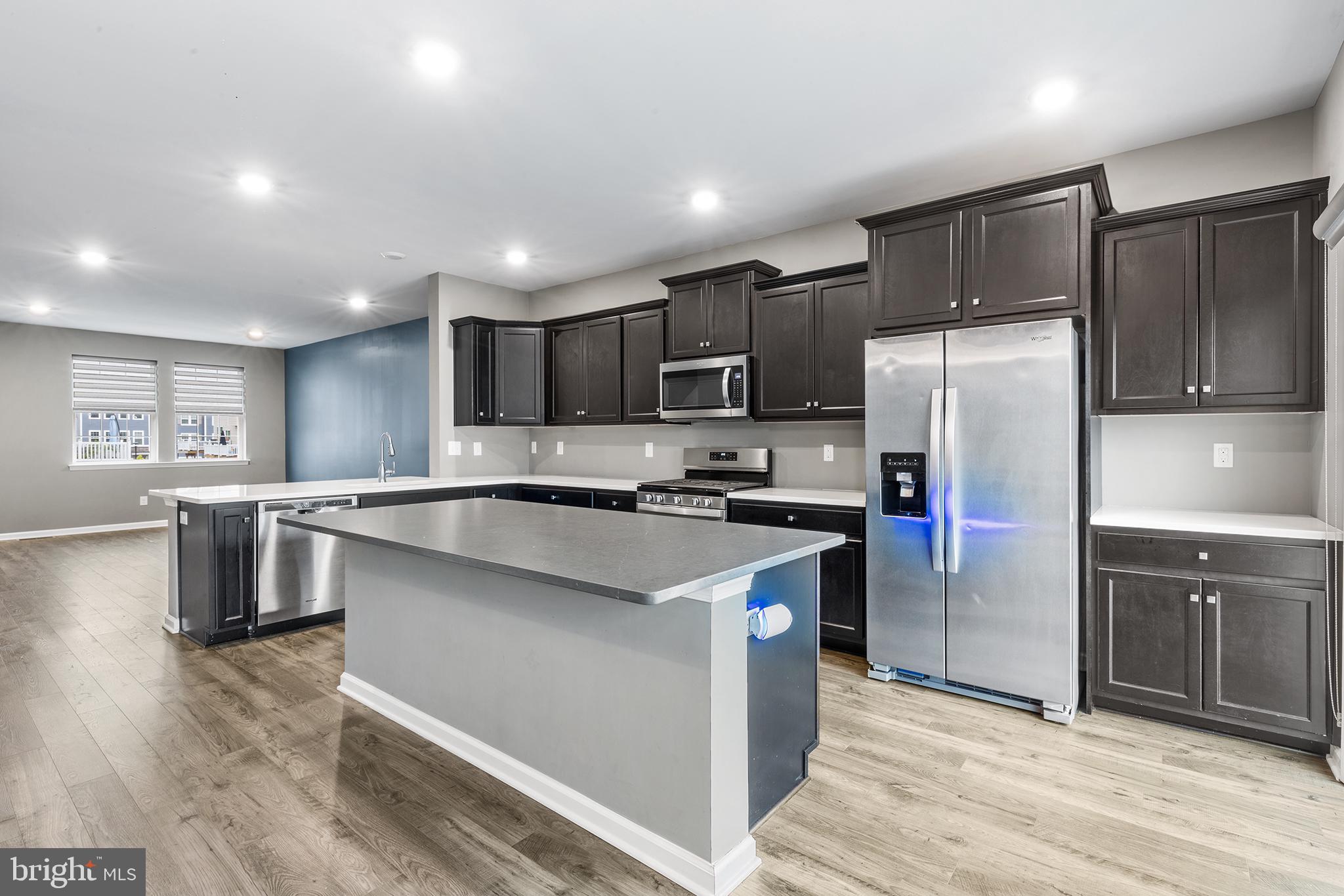 62 Rome Way Mount Laurel, NJ 08054 - Photo 5 of 31 a kitchen with kitchen island a refrigerator sink and cabinets