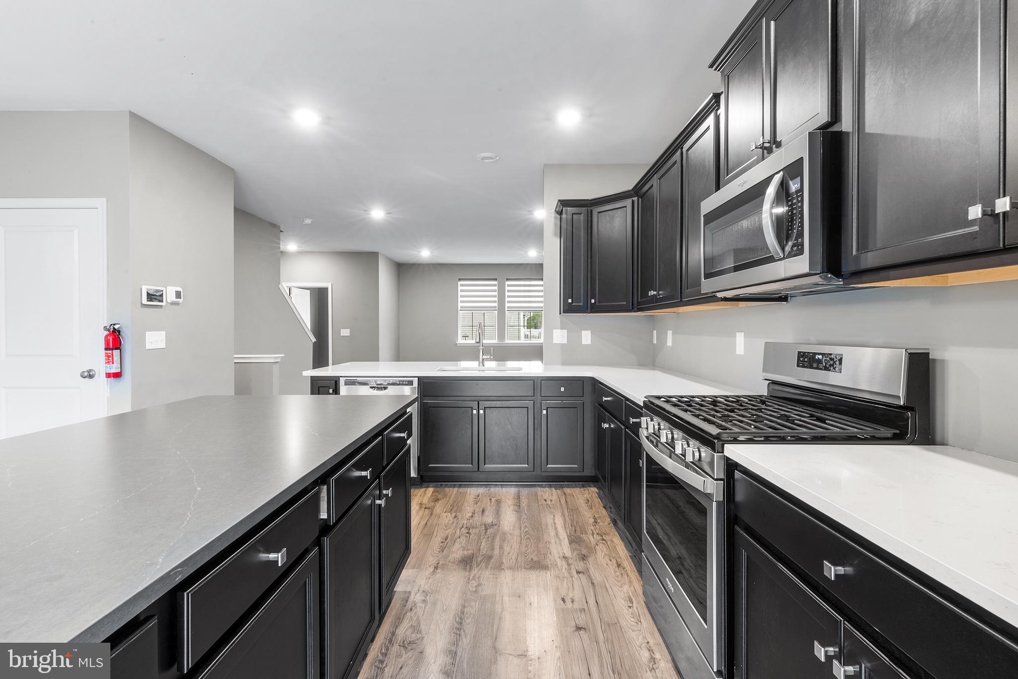 62 Rome Way Mount Laurel, NJ 08054 - Photo 6 of 31 a kitchen with stainless steel appliances granite countertop a sink a stove and a refrigerator