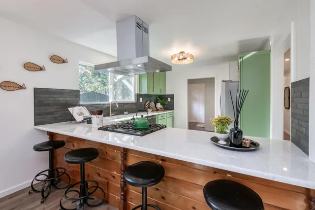 a kitchen with a stove a sink and a cabinets