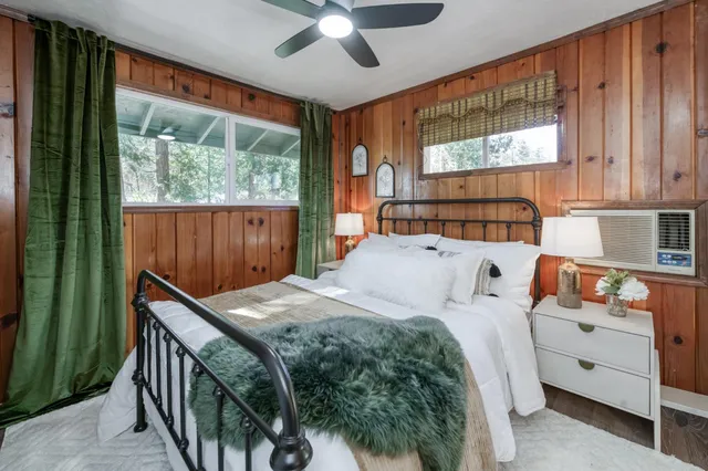 a bedroom with a large bed and a chandelier