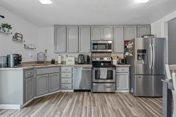 a kitchen with a refrigerator stove and sink