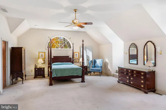 a bedroom with furniture and a chandelier