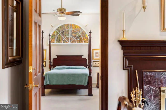 a bedroom with a bed and a mirror