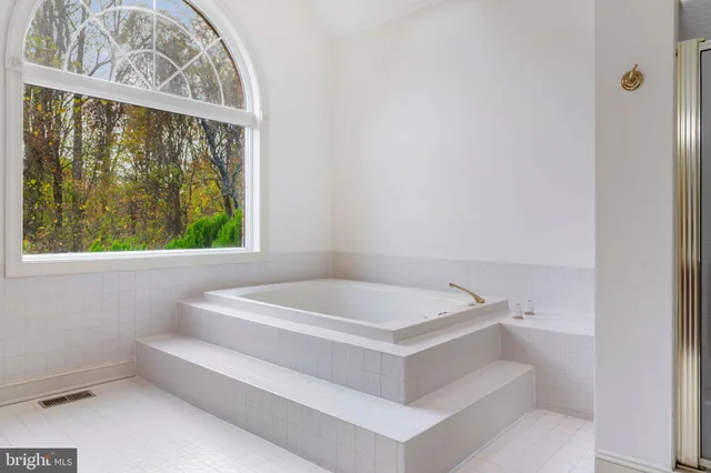 a bathroom with a bathtub and window