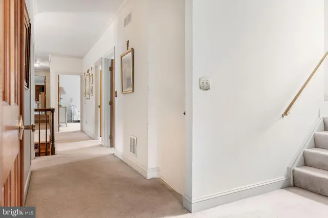 a view of a hallway with closet and furniture
