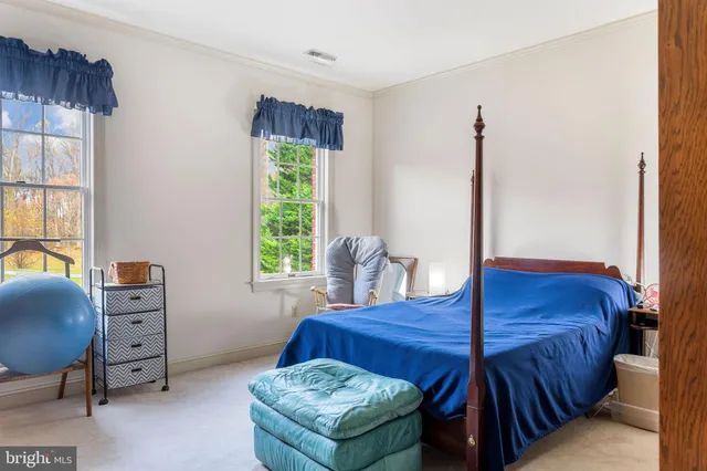 a bed room with a bed and a chair