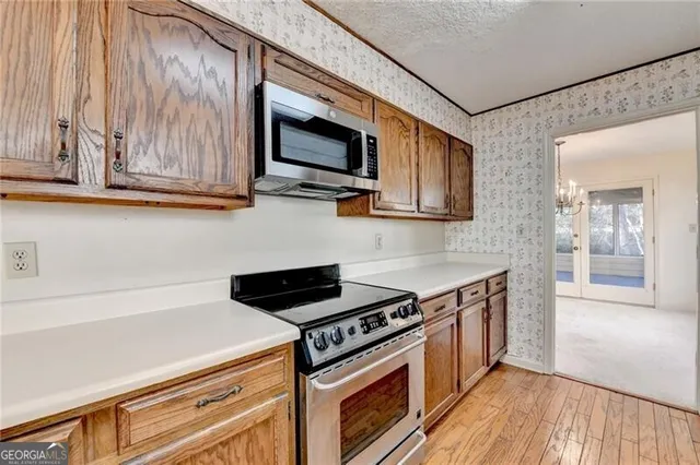 a view of kitchen with furniture and large windows