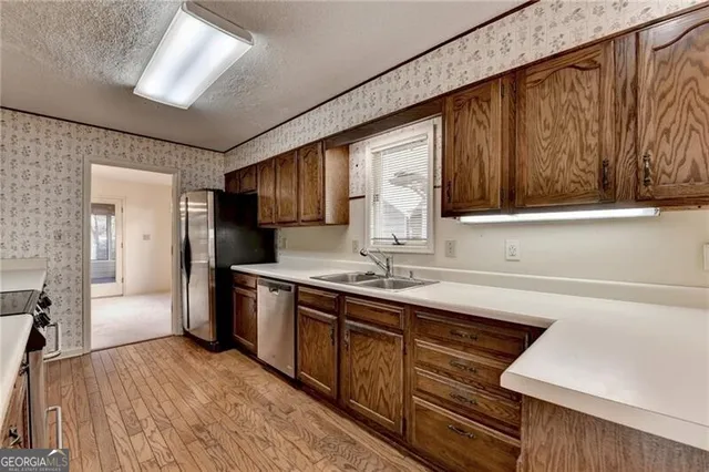 a view of empty room with fireplace and wooden floor