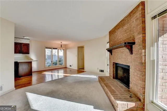 a spacious bedroom with a bed a couch and large windows