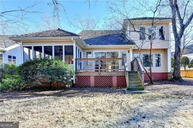 an aerial view of a house with a yard and lake view