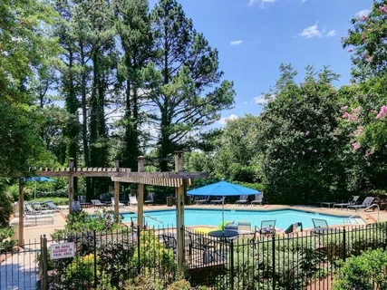 a view of a garden with a patio and fire pit