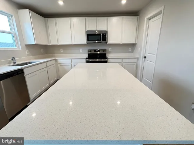 a kitchen with a sink a stove and refrigerator