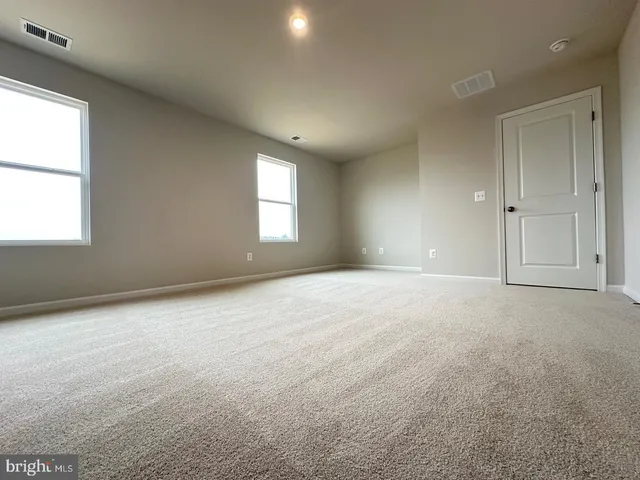 an empty room with closet and a bathroom