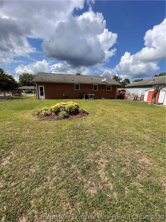 611 Reggie Court Spring Lake, NC 28390 - Photo 2 of 2 a view of a big yard with an buildings