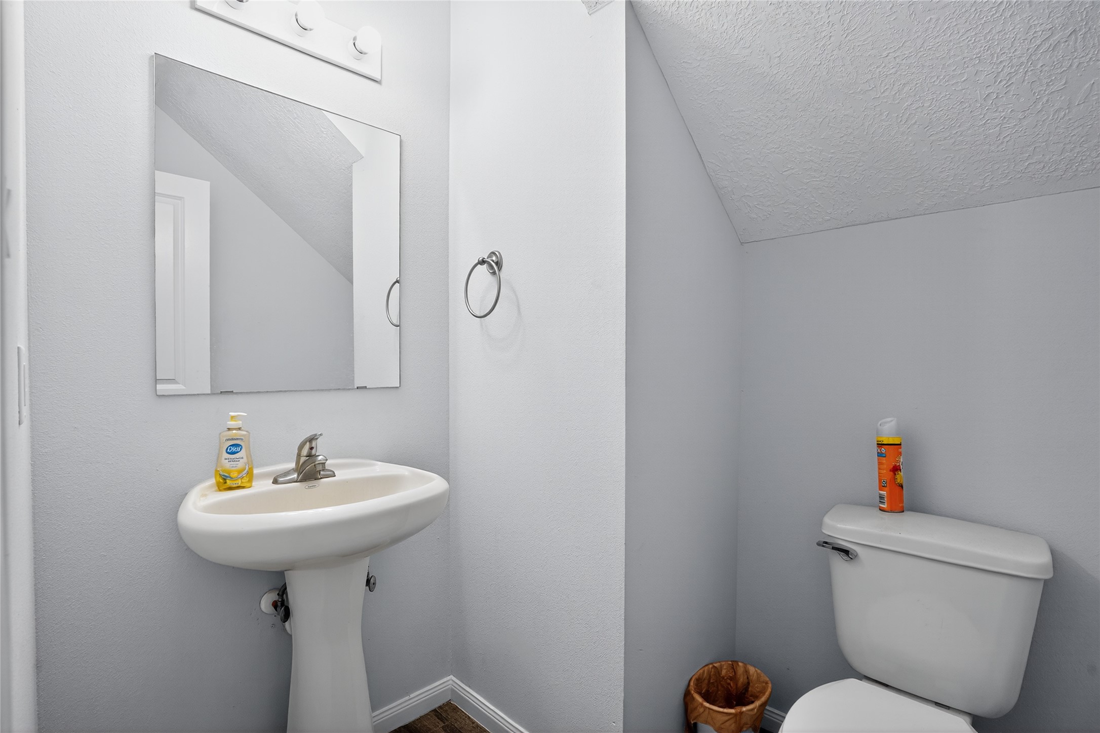 14986 Crockett Road Willis, TX 77378 - Photo 13 of 16 a bathroom with a toilet sink and mirror