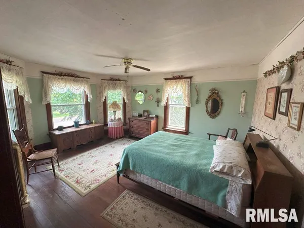 a bedroom with a large bed and window