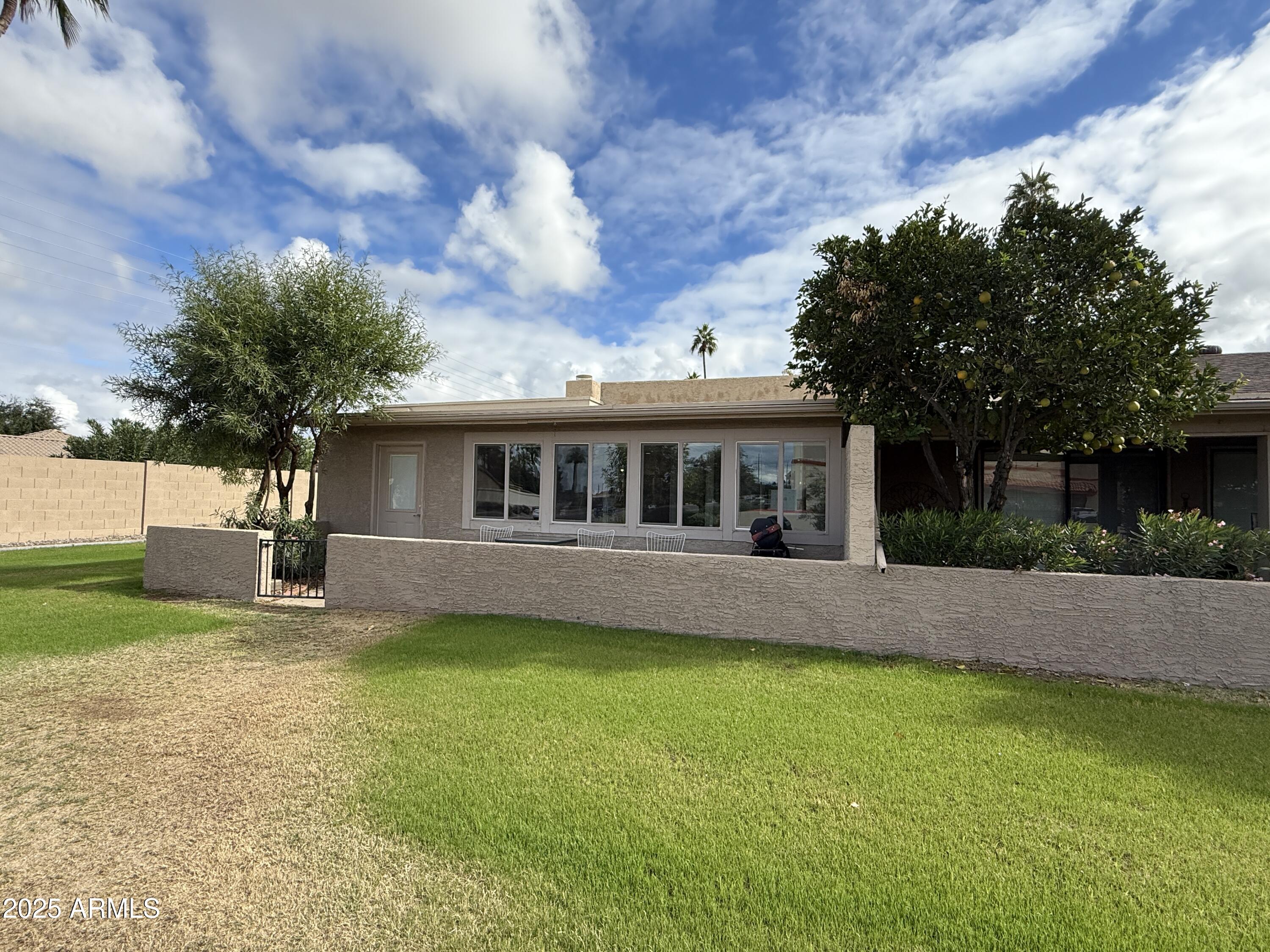 25208 South Angora Court Sun Lakes, AZ 85248 - Photo 13 of 22 a front view of house with yard and trees in the background