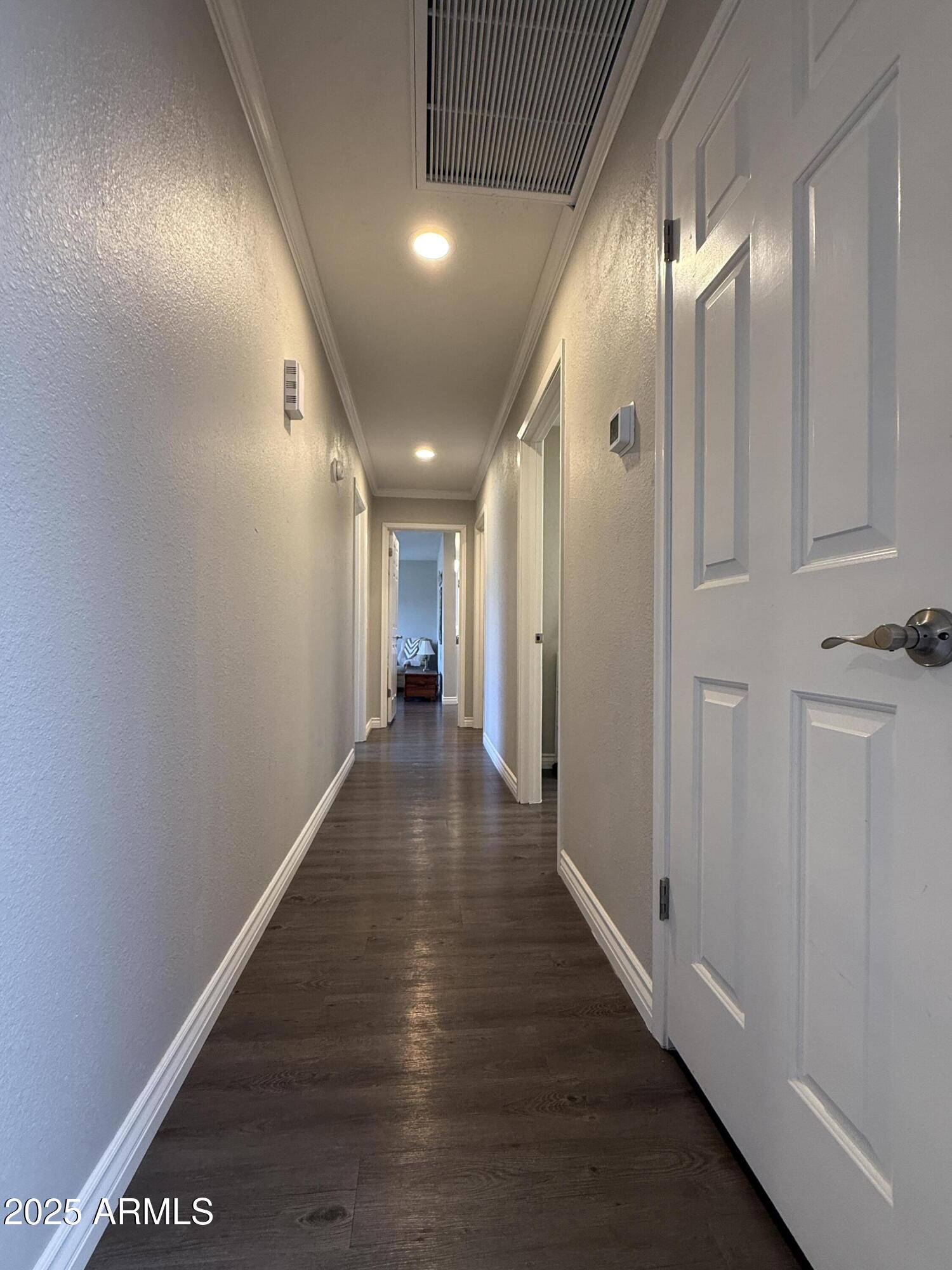 25208 South Angora Court Sun Lakes, AZ 85248 - Photo 15 of 22 a view of a hallway with wooden floor